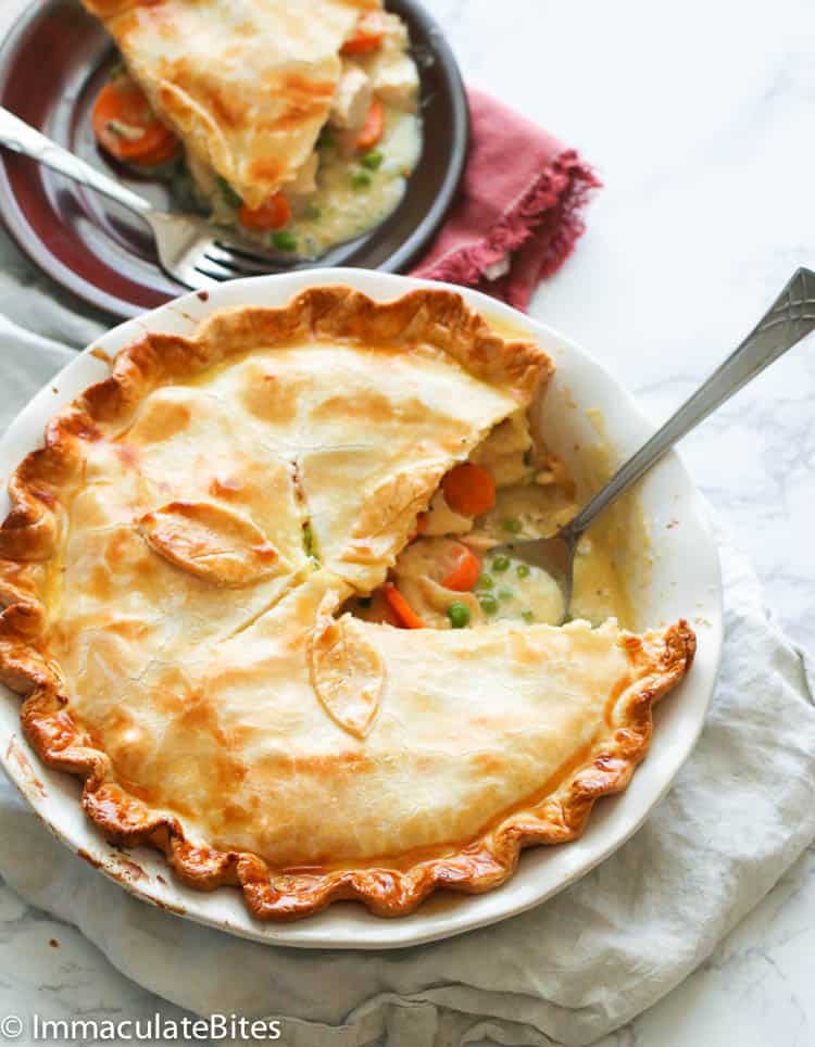 Sliced Homemade Chicken Pot Pie with a Serving Plate in the Background