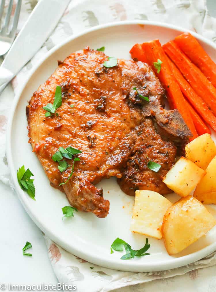 Freshly baked pork chops with carrots and potatoes ready to enjoy