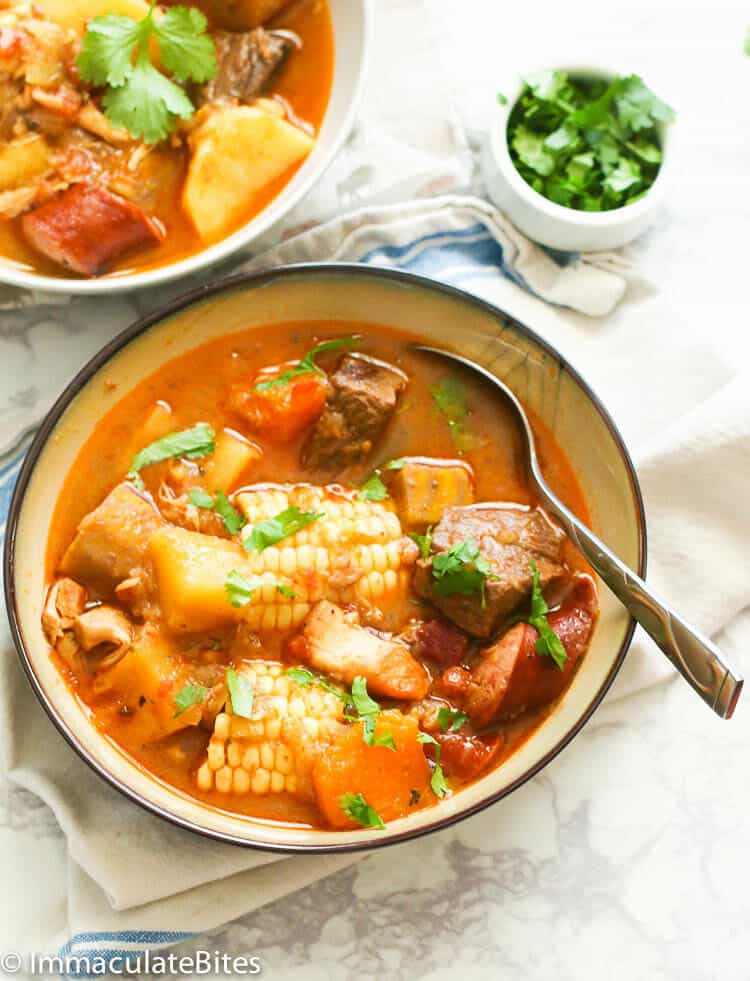 a bowl of sancocho recipe garnished with parsley