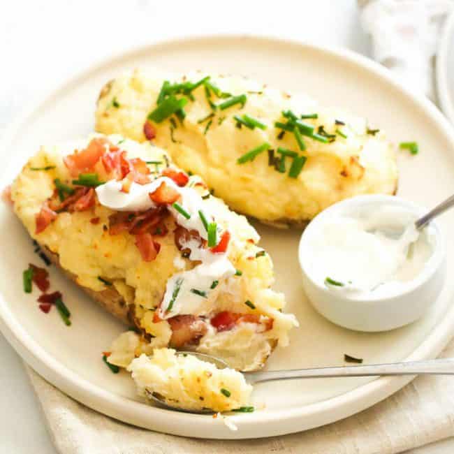 Topping already insanely good twice baked mashed potatoes with more bacaon and sour cream