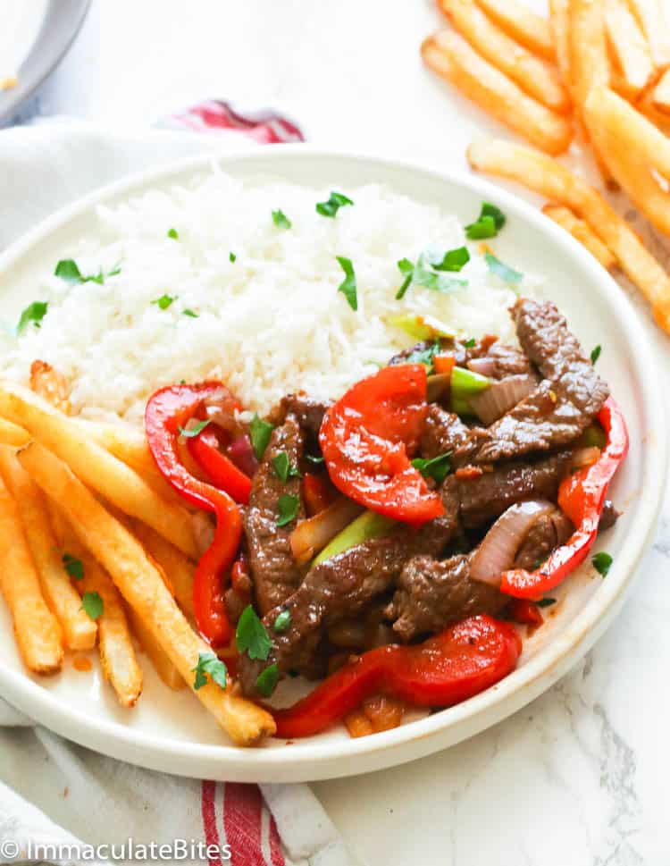 Lomo saltado with french fries and rice