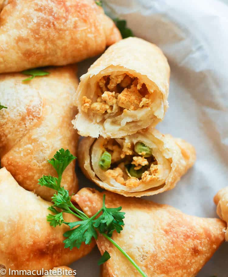 Breaking into a freshly made samosa with chicken filling