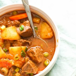 Guinness beef stew with potatoes and carrots in a white bowl