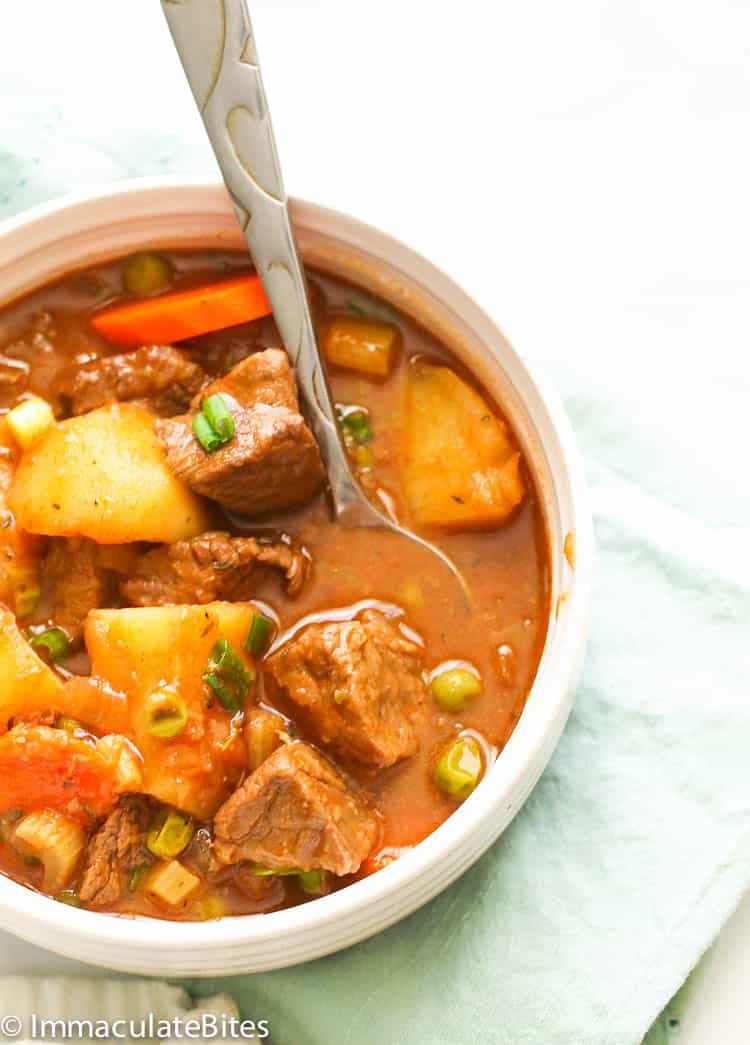 Guinness beef stew with potatoes and carrots in a white bowl