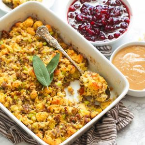 Cornbread dressing fresh from the oven with homemade cranberry sauce