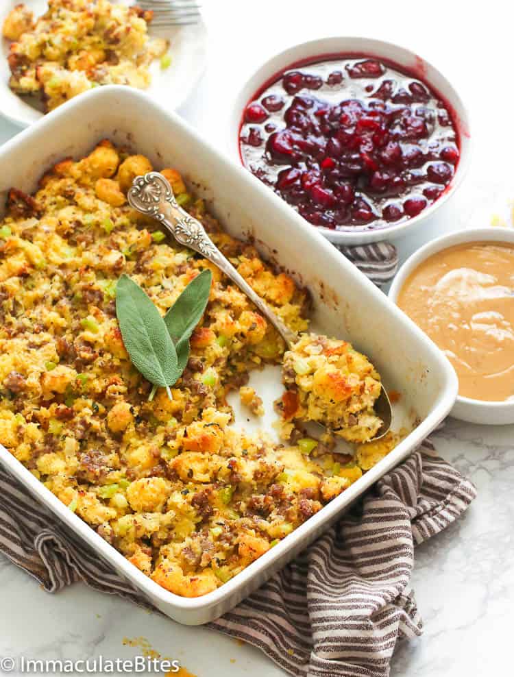 Cornbread dressing fresh from the oven with homemade cranberry sauce