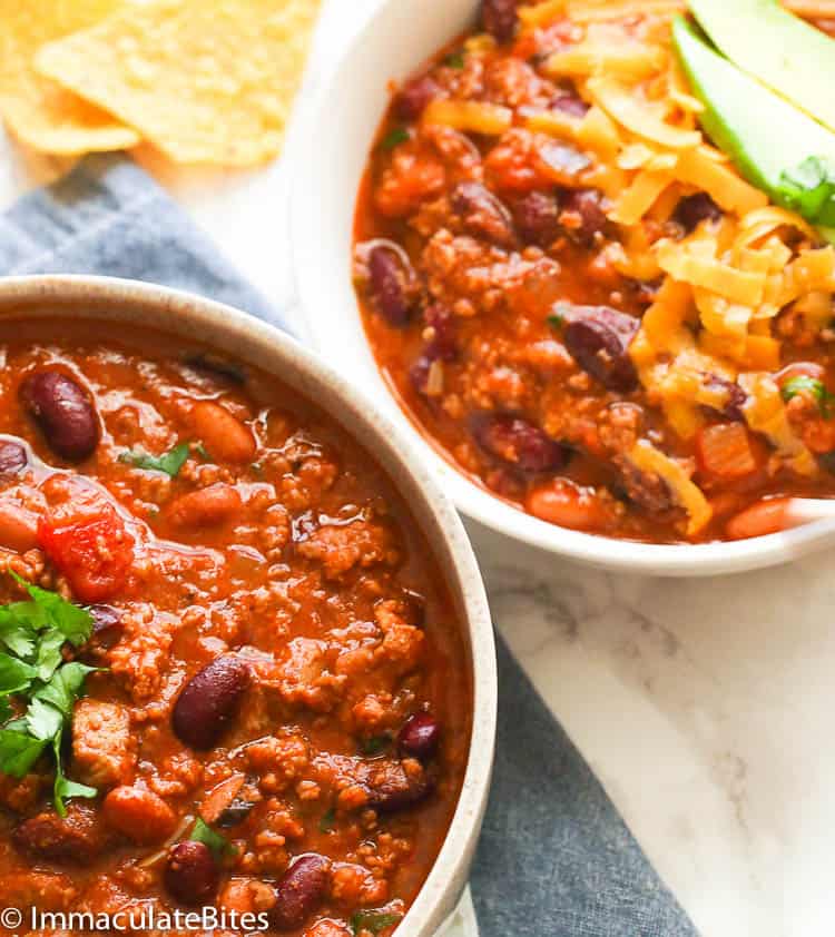 Two Bowls of Chili with Tortilla Chips in the Background