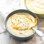 A delicious bowl of savory grits topped with a fried egg