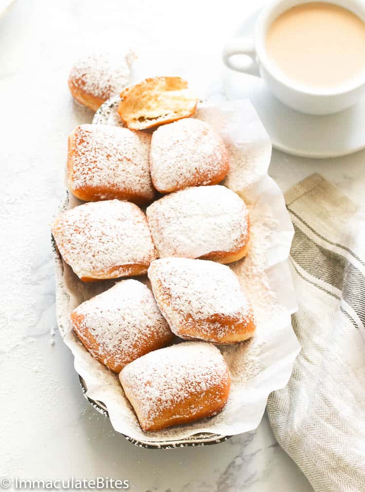 Beignets served in a platter plus a cup of coffee