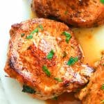 Stuffed Pork Chops drizzled with pan drippings for a decadent weeknight meal