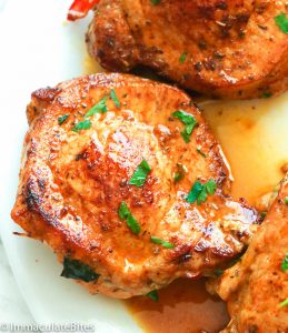 Stuffed Pork Chops drizzled with pan drippings for a decadent weeknight meal