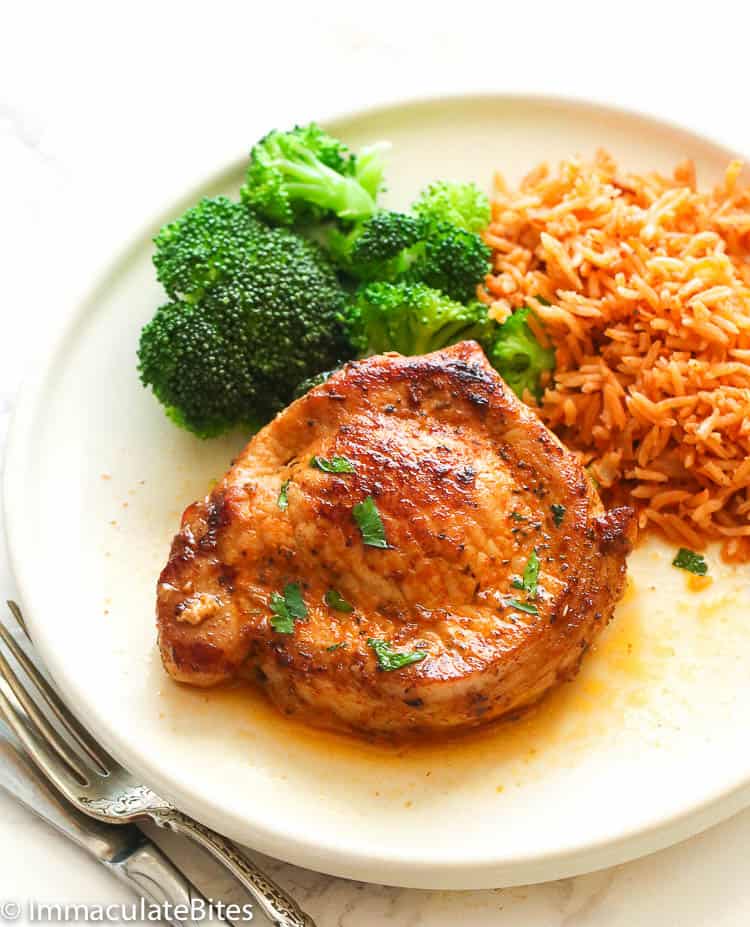 Enjoying a stuffed pork chop with seasoned rice and steamed broccoli