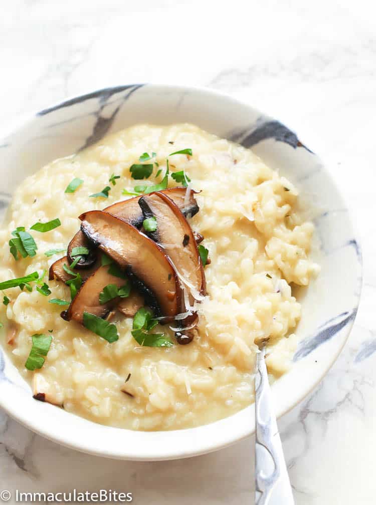 a bowl of Mushroom Risotto garnished with chopped parsley and shredded cheese