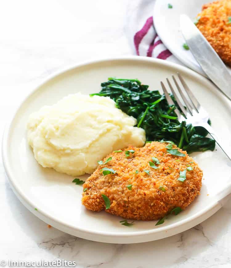 Breaded Chops Served with Creamy Mashed Potatoes and Sauteed Spinach