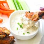 Blue cheese dressing with celery and chicken wings