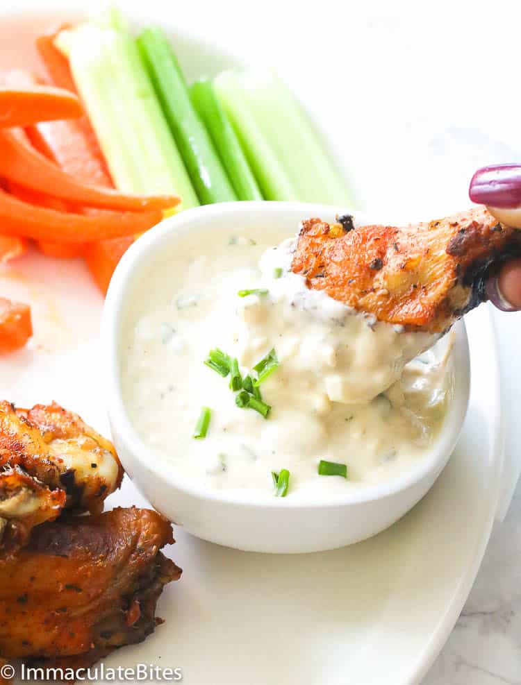 Blue cheese dressing with celery and chicken wings