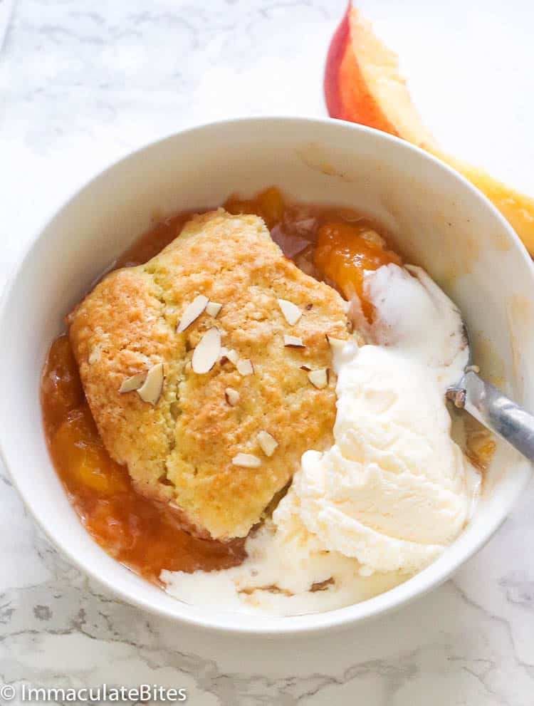 Peach Cobbler in a Bowl Topped with Vanilla Ice Cream