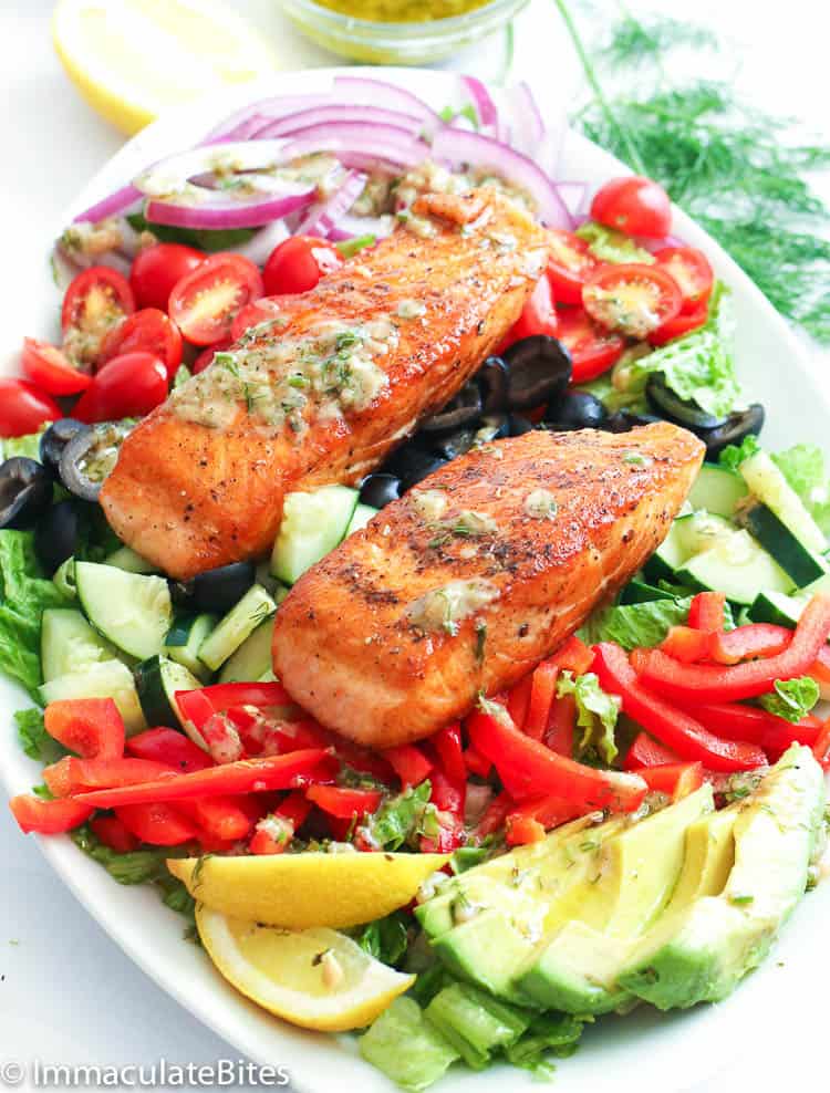pan-seared salmon on a bed of Romaine lettuce and colorful veggies