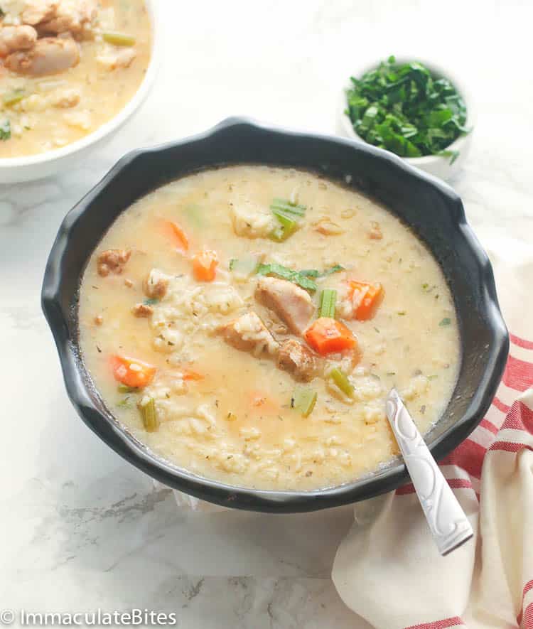 Chicken and rice soup in a black bowl