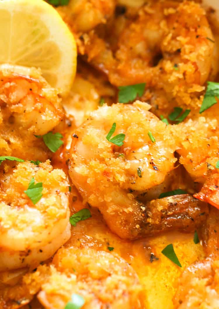 Baked shrimp closeup with a lemon wedge