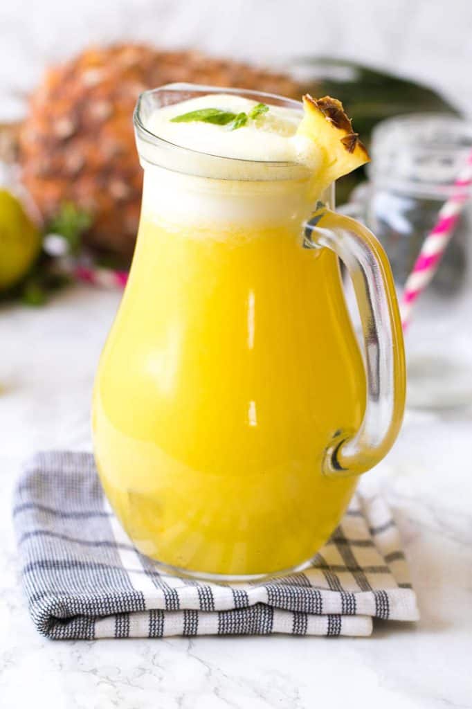 Pineapple juice in a glass pitcher