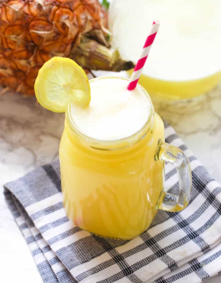 Homemade Pineapple Juice garnished with a lemon slice ready to enjoy