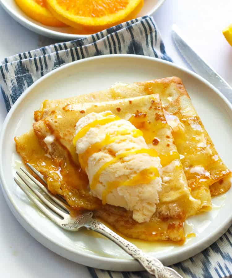 Crepe Suzette topped with vanilla ice cream