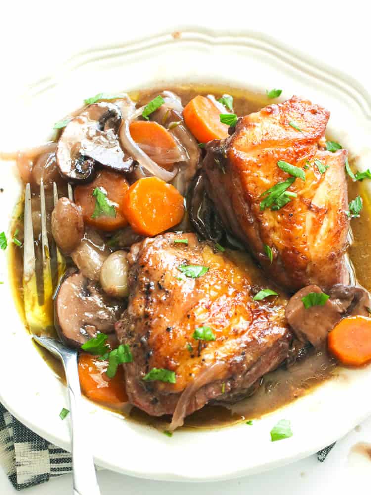 Coq au vin in a plate with fork