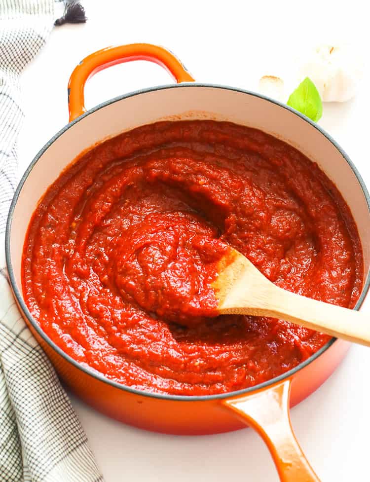 Stirring a pot of delicious homemade pizza sauce