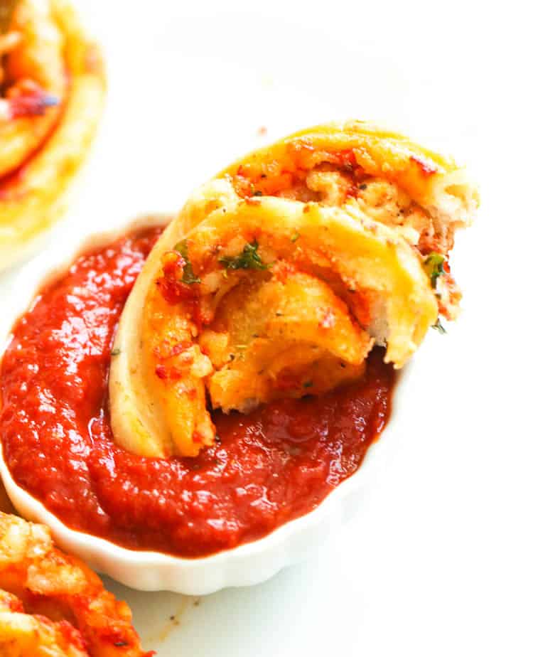 Dipping the pizza roll in red sauce