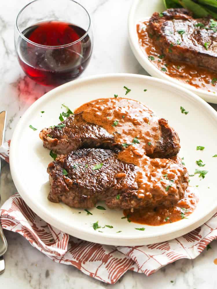 Enjoying delectable steak Diane with a glass of red wine