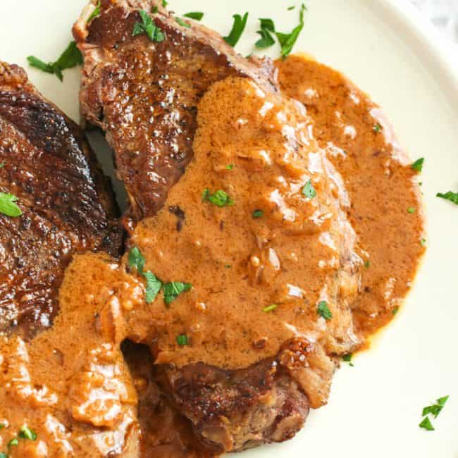 Enjoying a closeup of steak smothered in steak Diane sauce