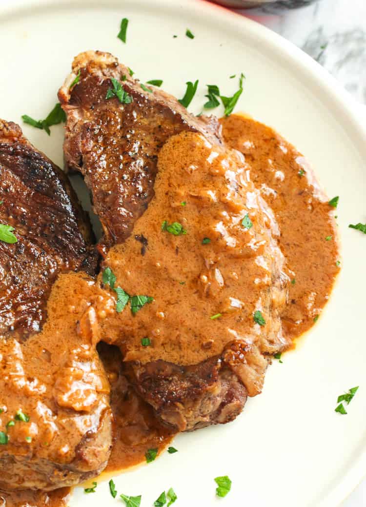 Enjoying a closeup of steak smothered in steak Diane sauce