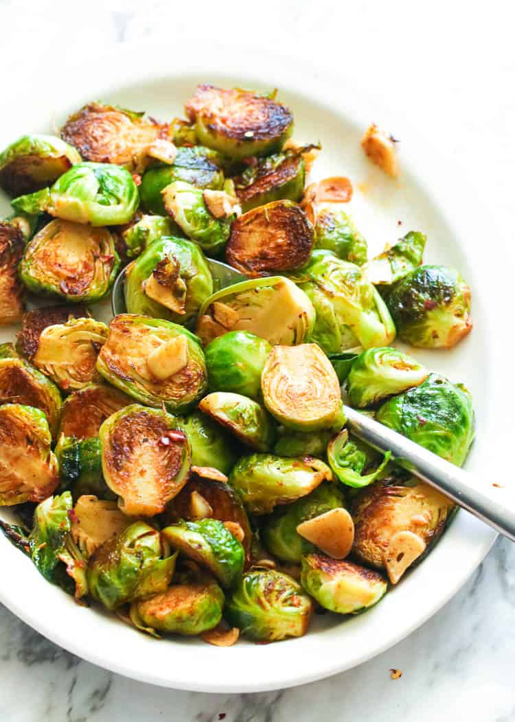 Sauteed Brussel Sprouts in a plate with spoon