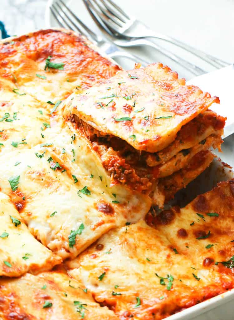 A Slice of Easy Lasagna Being Pulled Out of the Baking Dish