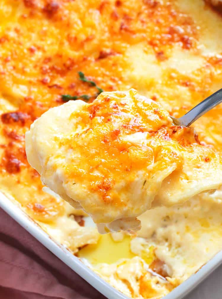 Cheesy Potatoes au Gratin Being Spooned