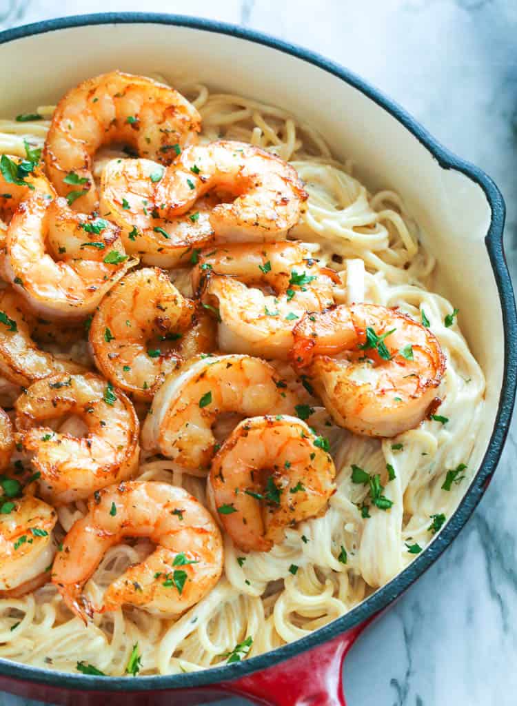 Spaghetti noodles in creamy pasta sauce topped with jumbo shrimps