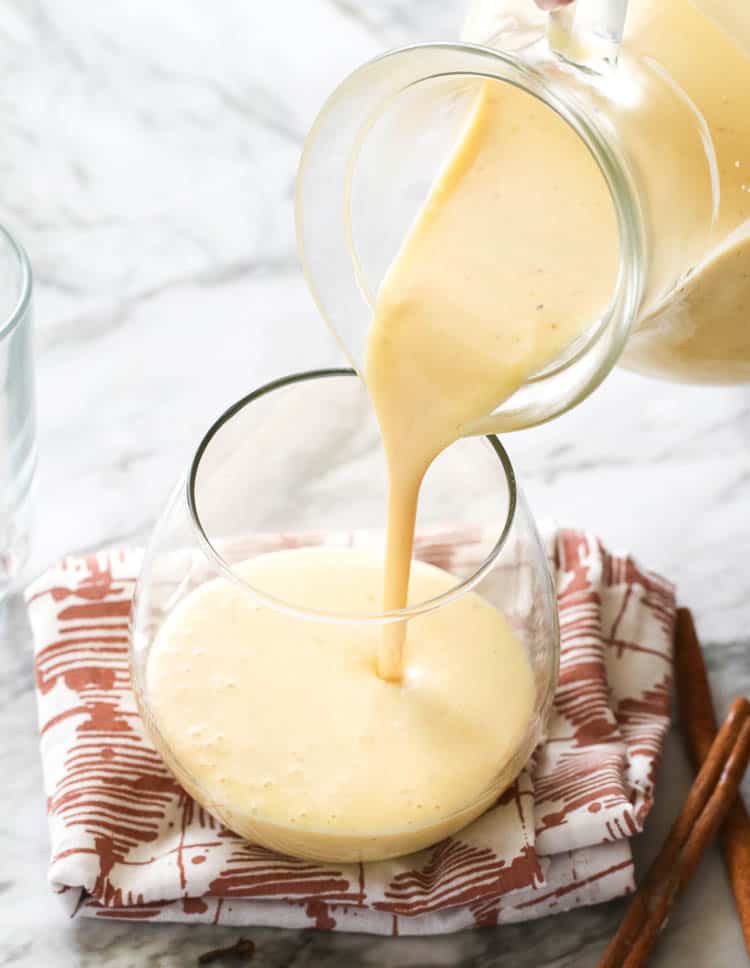 Homemade Eggnog Being Poured Down to a Glass