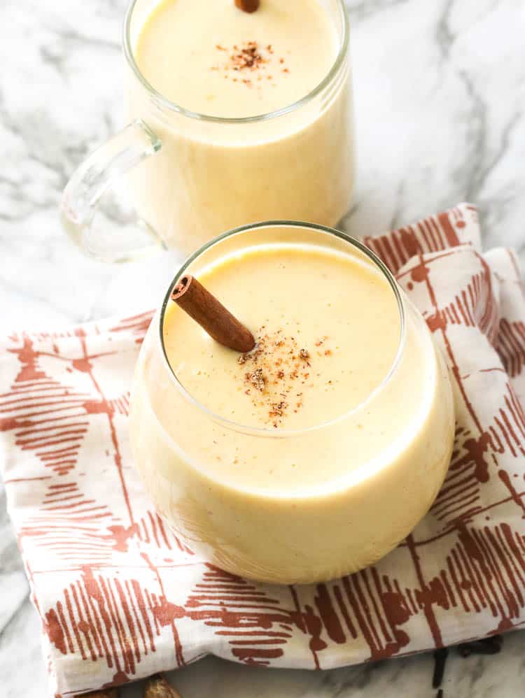 Two Glasses of Homemade Eggnog with cinnamon stick