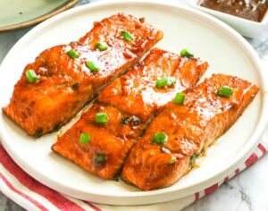 Umami, spicy, sweet Teriyaki Salmon on a white plate