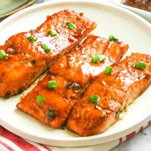 Umami, spicy, sweet Teriyaki Salmon on a white plate