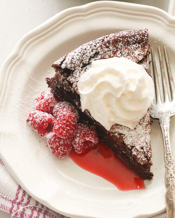 Flourless Chocolate Cake with raspberries and homemade whipped cream perfect for Mother's Day