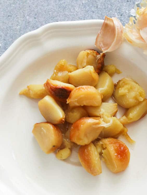 Roasted Garlic Cloves on a White Plate
