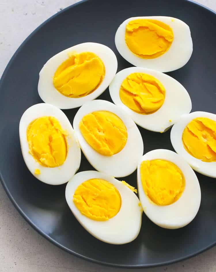 Sliced Boiled Eggs on a Black Plate