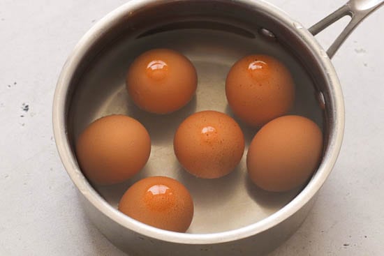 Placing Eggs in a Saucepan with Water