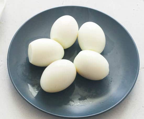 Five Peeled Boiled Eggs on a Plate