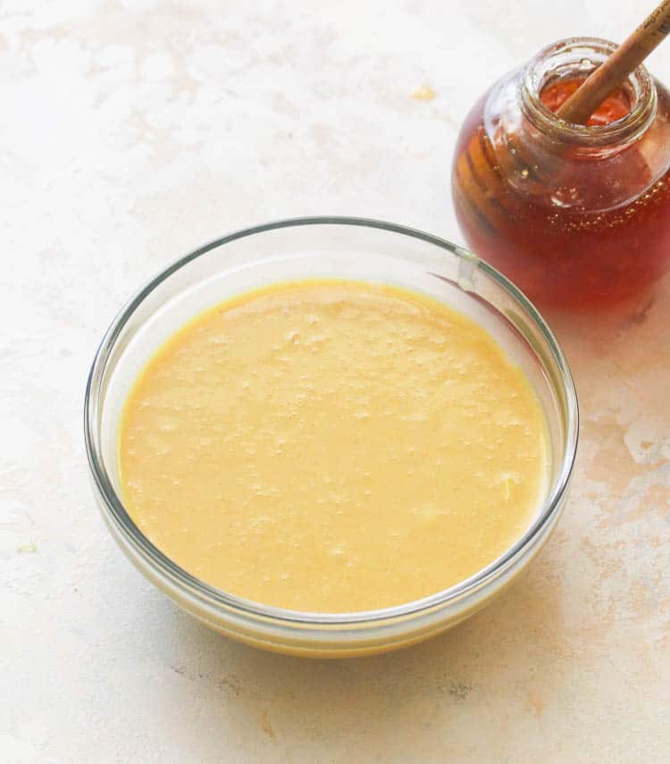Honey Mustard Dressing with Honey in the Background