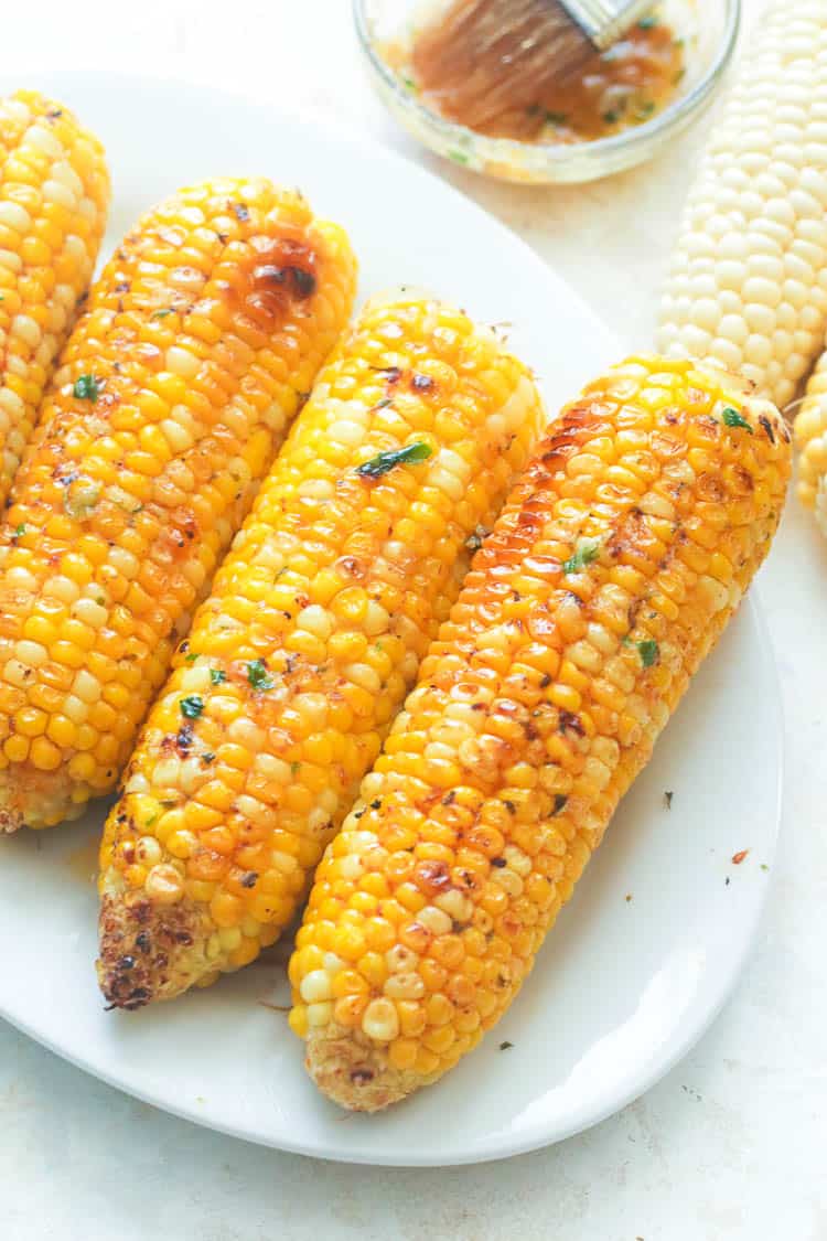 Oven Roasted Corn on the Cob served on a white platter