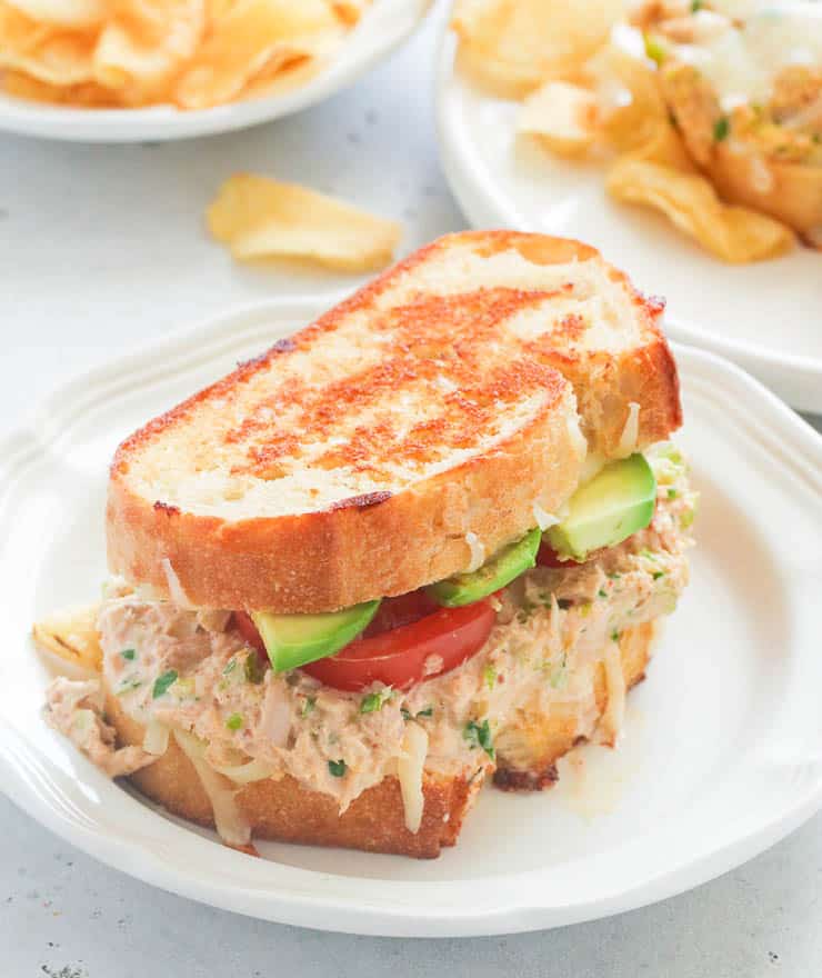Fully loaded Tuna Melt served on a white plate