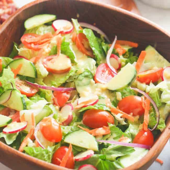 Tossed Salad in a wooden bowl ready to dress